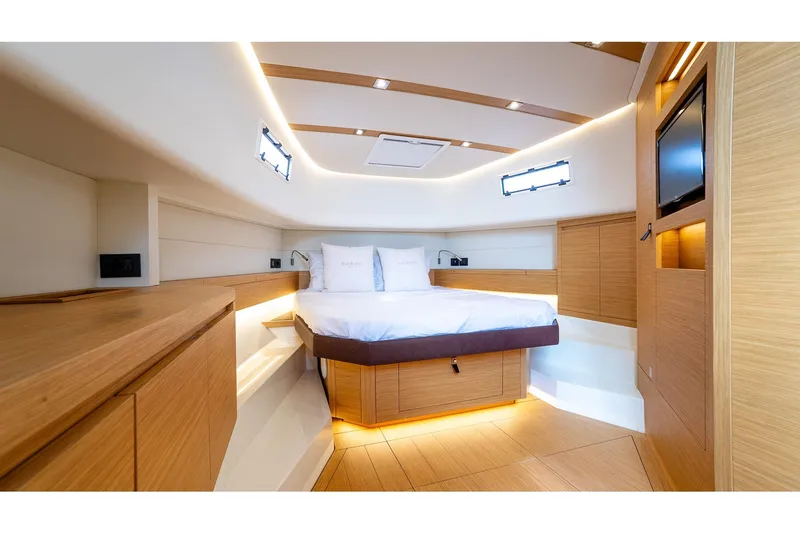  Yacht Photos Pics Luxurious cabin interior of 2024 Pardo Yachts 43, featuring modern wood finishes and ambient lighting.