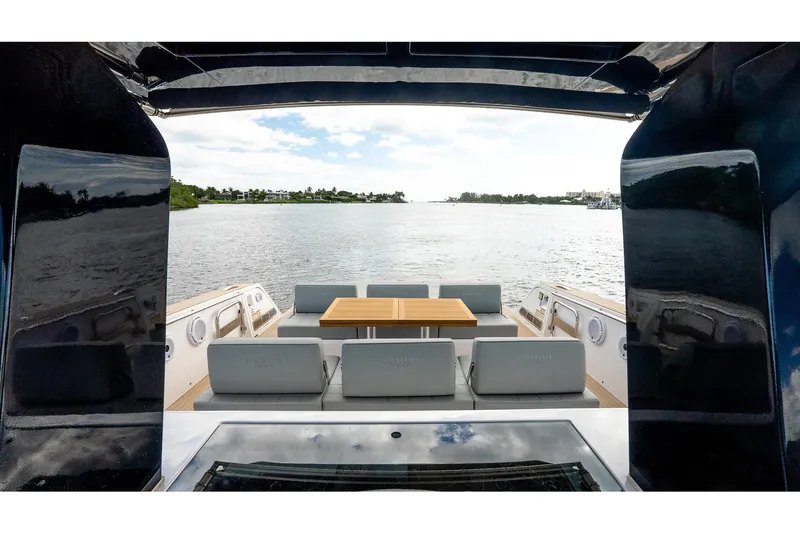  Yacht Photos Pics 2024 Pardo Yachts 43, elegant deck view with seating and table, overlooking serene waters.