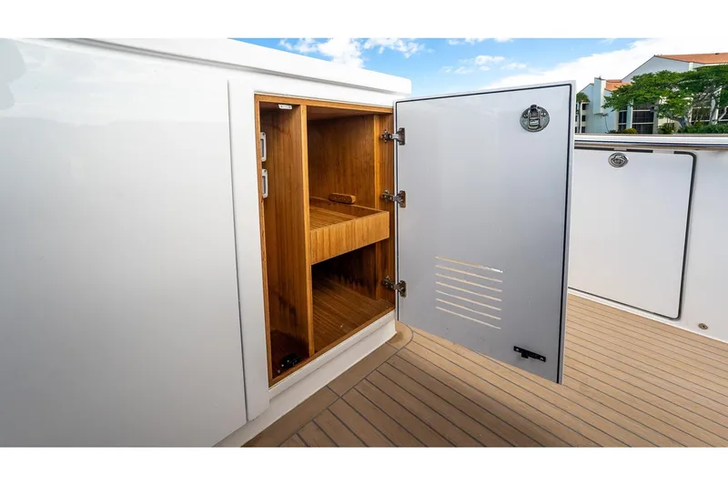  Yacht Photos Pics Open storage compartment on 2024 Pardo Yachts 43, featuring wooden interior shelves.