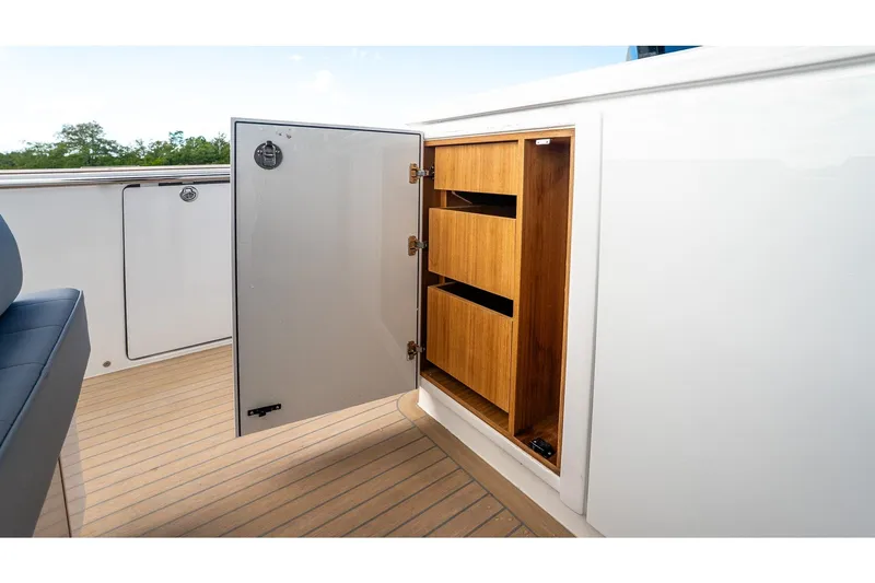  Yacht Photos Pics Open storage compartment on 2024 Pardo Yachts 43, featuring wooden shelves and sleek design.