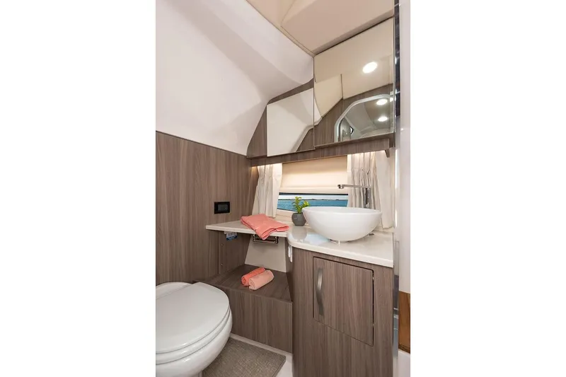  Yacht Photos Pics Manufacturer Provided Image: Modern bathroom in 2019 Regal 33 SAV boat with sink, toilet, and storage.