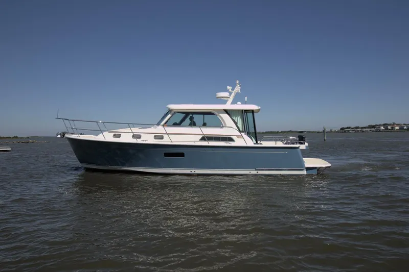 Flight Level Zero Yacht Photos Pics 2013 Sabre 38 Salon Express cruising on calm waters under clear blue sky.