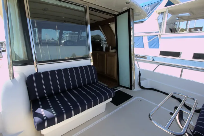 Flight Level Zero Yacht Photos Pics 2013 Sabre 38 Salon Express yacht with striped seating and open cabin door.