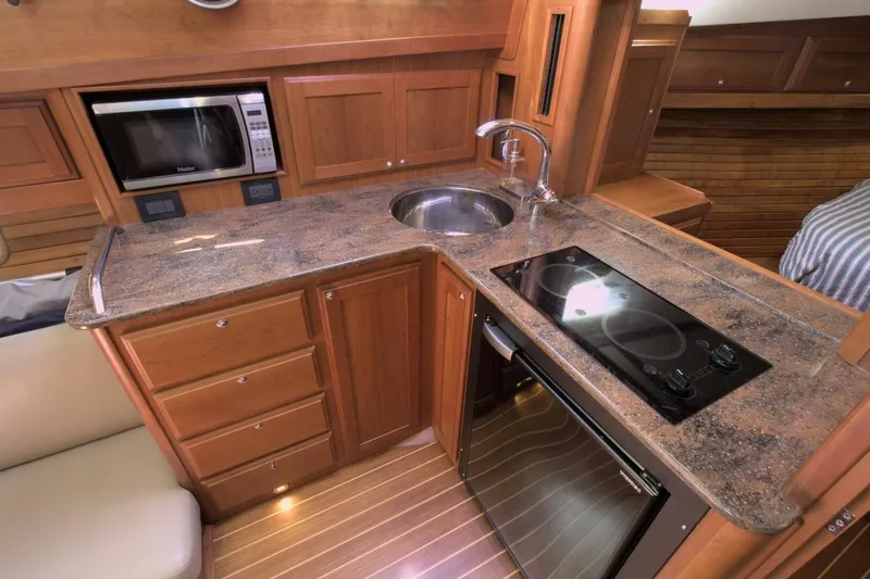 Flight Level Zero Yacht Photos Pics 2013 Sabre 38 Salon Express kitchen with granite countertops, stove, sink, and microwave.