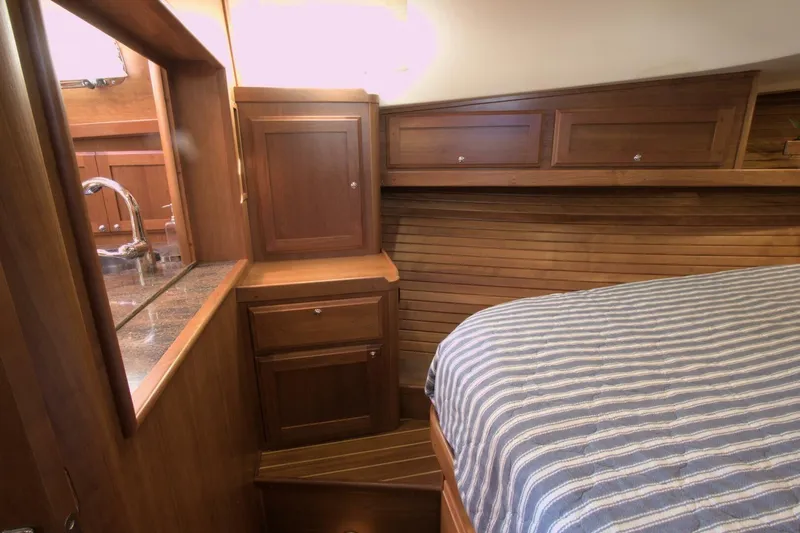 Flight Level Zero Yacht Photos Pics 2013 Sabre 38 Salon Express interior with wood cabinetry and striped bedding.
