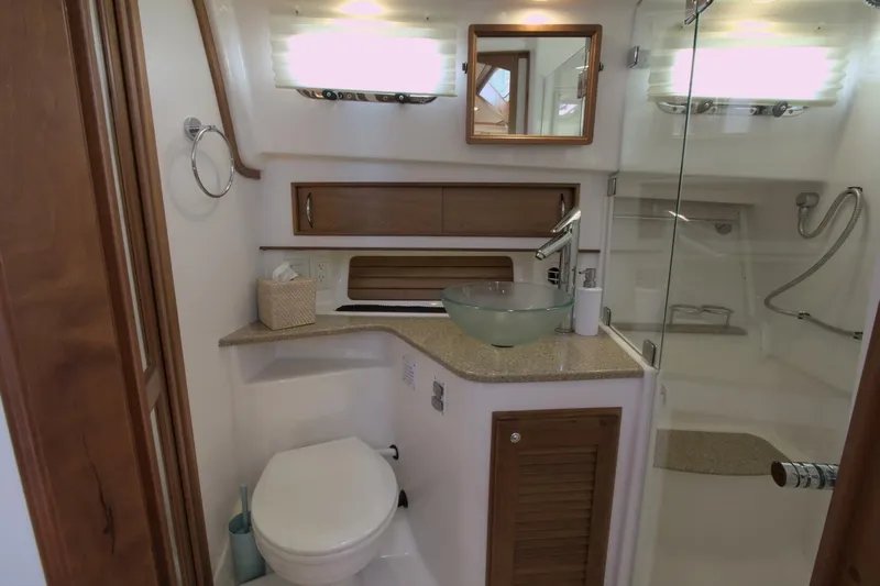 Flight Level Zero Yacht Photos Pics Luxurious bathroom in 2013 Sabre 38 Salon Express yacht with modern fixtures and glass shower.