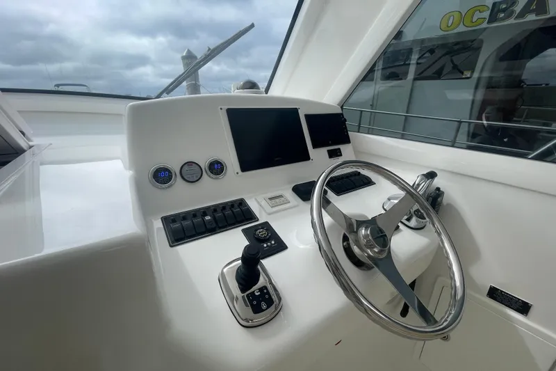 Lady Faye Yacht Photos Pics 2018 Viking 37 Billfish helm with steering wheel, controls, and navigation screens.