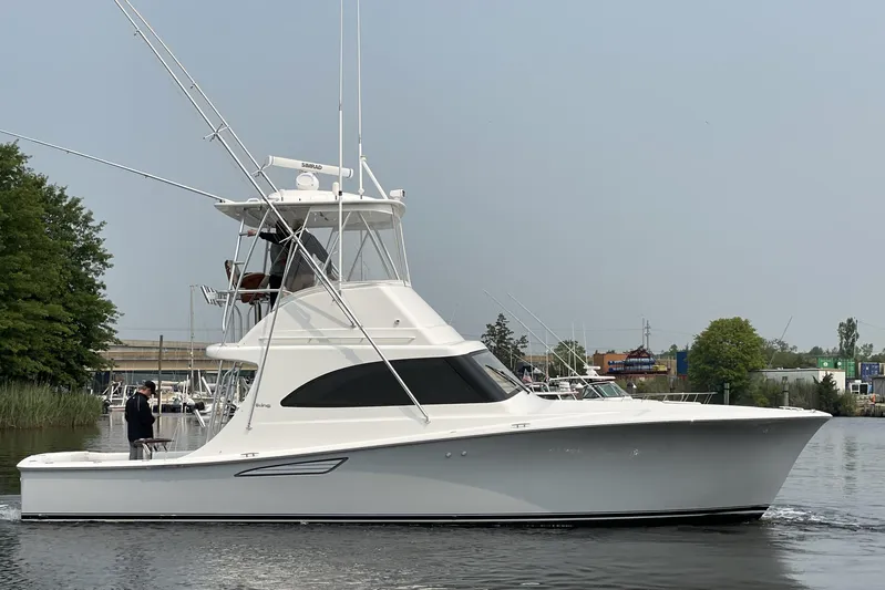 Lady Faye Yacht Photos Pics 2018 Viking 37 Billfish yacht on calm water, side view with trees in background.