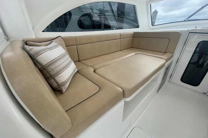 Lady Faye Yacht Photos Pics 2018 Viking 37 Billfish interior with beige seating and striped pillow.