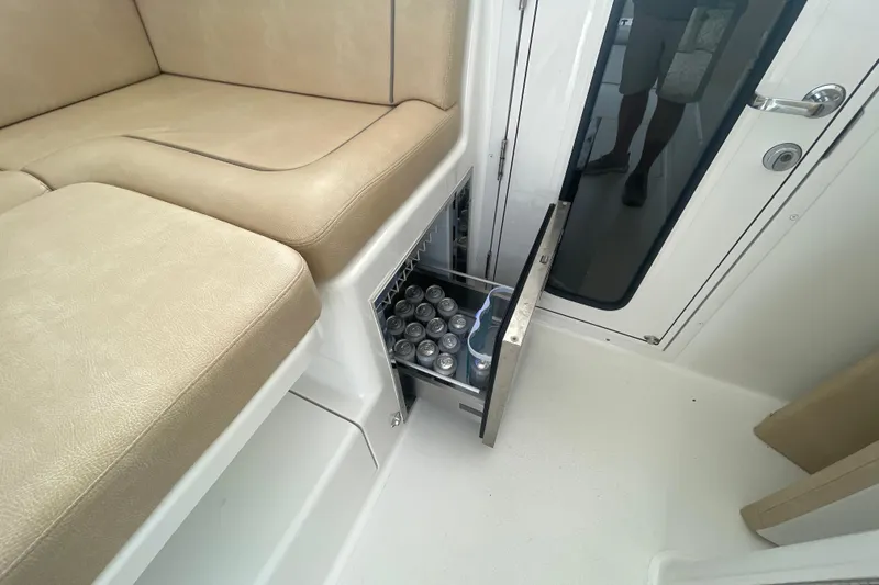 Lady Faye Yacht Photos Pics 2018 Viking 37 Billfish interior with beige seating and built-in beverage storage drawer.