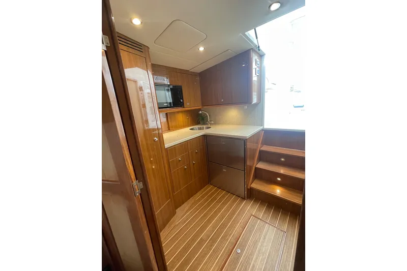 Lady Faye Yacht Photos Pics Luxurious 2018 Viking 37 Billfish yacht interior with modern kitchen and wooden cabinetry.