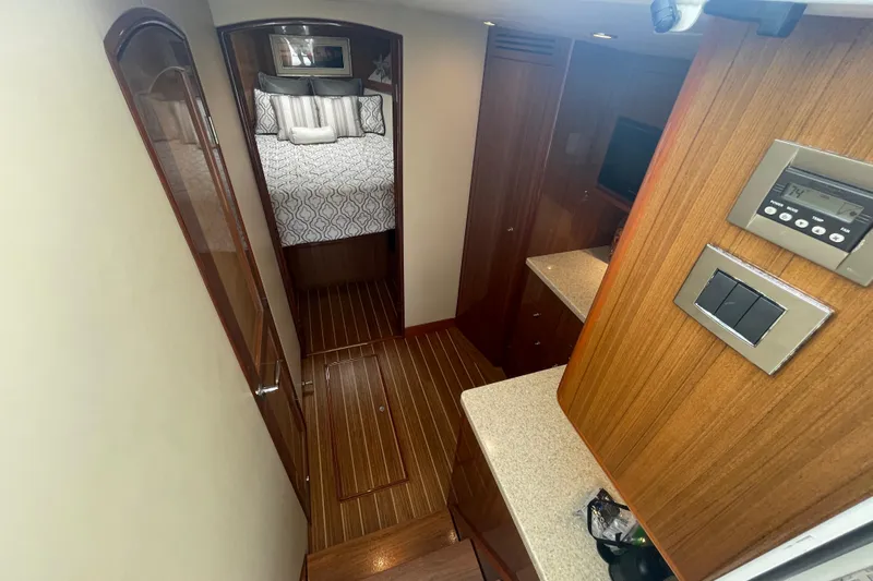 Lady Faye Yacht Photos Pics Interior of 2018 Viking 37 Billfish yacht with wood paneling and cozy bedroom.