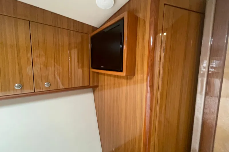 Lady Faye Yacht Photos Pics Interior of 2018 Viking 37 Billfish with wood paneling and mounted TV.