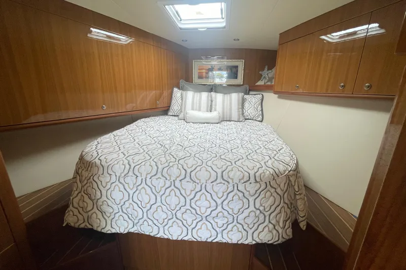 Lady Faye Yacht Photos Pics Luxurious cabin interior of 2018 Viking 37 Billfish with elegant bedding and wood paneling.
