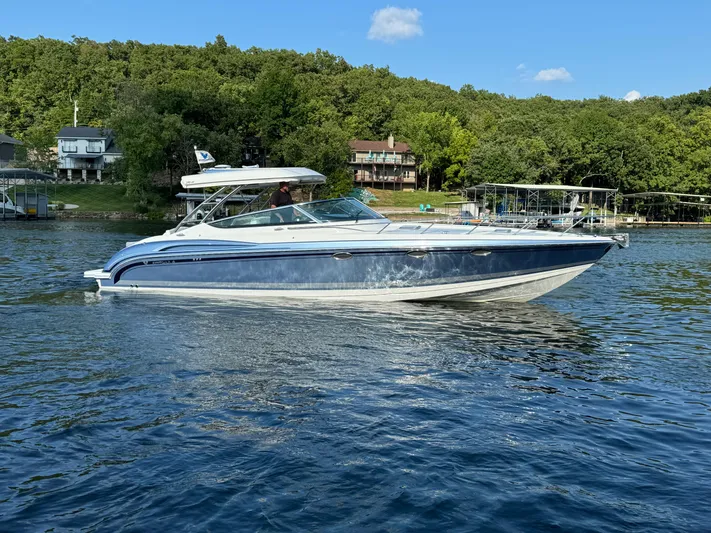  Yacht Photos Pics 2020 Formula 370 SS boat on a serene lake with lush green shoreline.