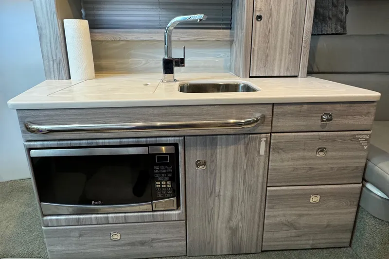  Yacht Photos Pics 2020 Formula 370 SS kitchenette with sink, microwave, and storage cabinets.