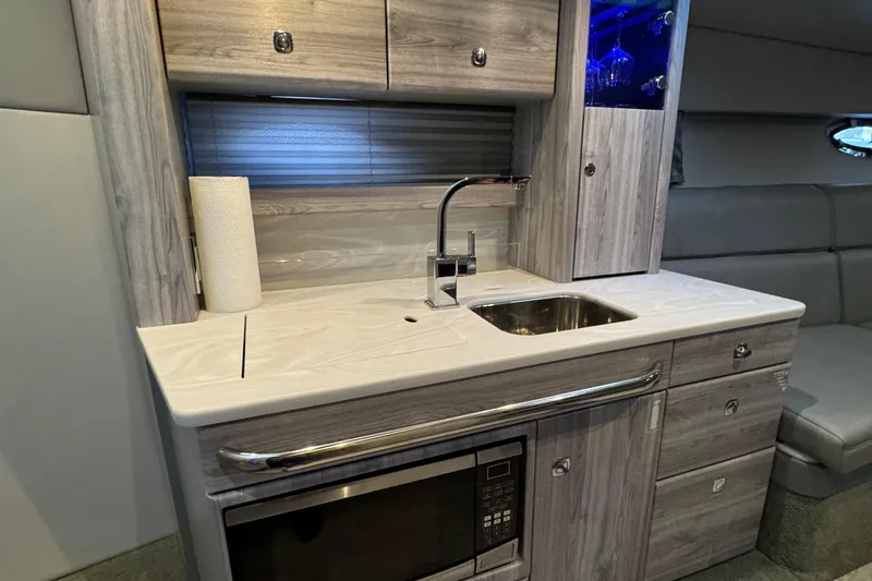  Yacht Photos Pics Modern kitchenette in 2020 Formula 370 SS boat with sink, microwave, and storage cabinets.