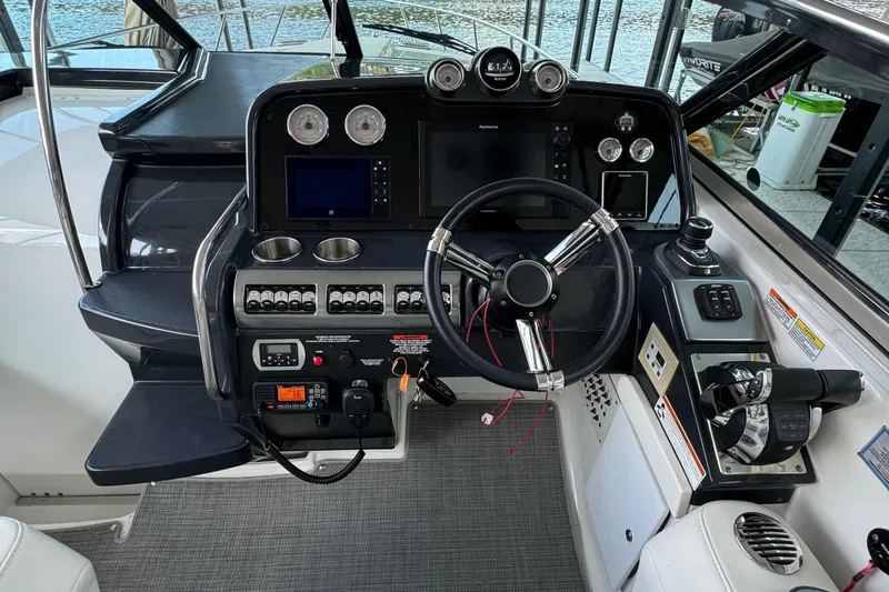  Yacht Photos Pics Cockpit of a 2020 Formula 370 SS boat with steering wheel and control panels.