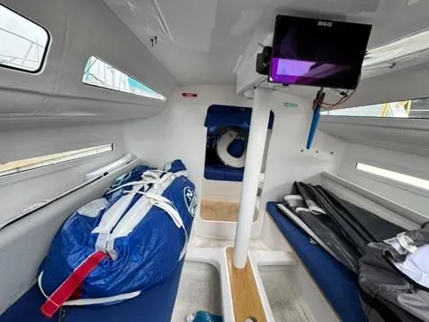 Sails Up Yacht Photos Pics Interior of 2022 Beneteau First 27 sailboat, featuring compact cabin and storage.