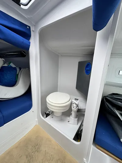 Sails Up Yacht Photos Pics Beneteau First 27 (2022) yacht interior with compact marine toilet.