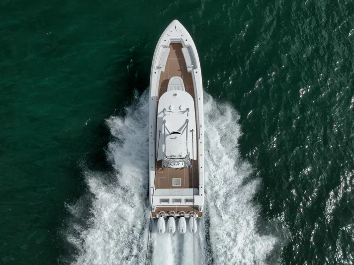  Yacht Photos Pics 2024 Contender 44 ST boat cruising on open water, aerial view.