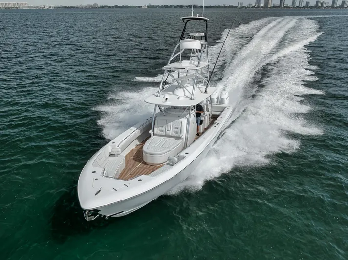  Yacht Photos Pics 2024 Contender 44 ST boat cruising on open water, showcasing sleek design and powerful performance.