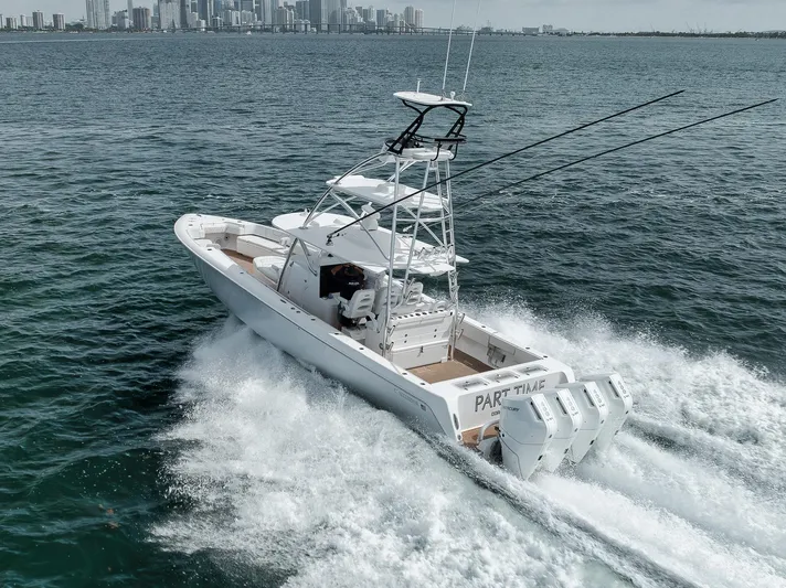  Yacht Photos Pics 2024 Contender 44 ST boat cruising on open water near city skyline.