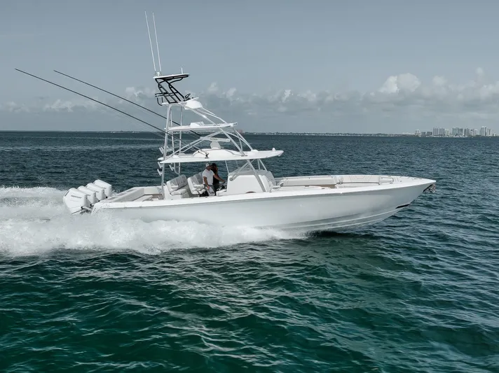  Yacht Photos Pics 2024 Contender 44 ST boat cruising on open water, showcasing sleek design and powerful engines.