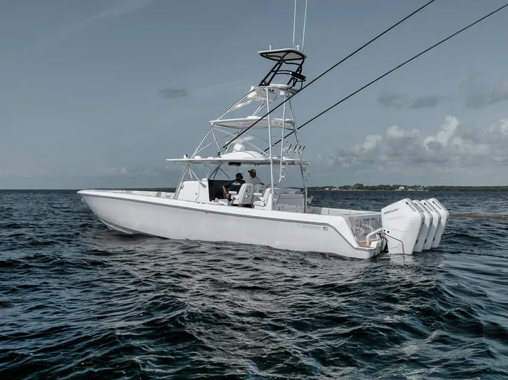  Yacht Photos Pics 2024 Contender 44 ST boat on open water, featuring sleek design and powerful engines.