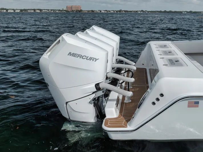  Yacht Photos Pics 2024 Contender 44 ST boat with multiple Mercury outboard engines on the water.