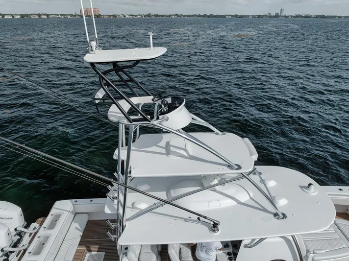  Yacht Photos Pics 2024 Contender 44 ST boat with elevated helm, cruising on open water.