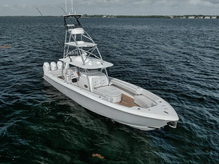  Yacht Photos Pics 2024 Contender 44 ST boat on open water, featuring sleek design and multiple engines.