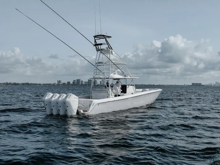  Yacht Photos Pics 2024 Contender 44 ST boat on open water with multiple outboard engines.