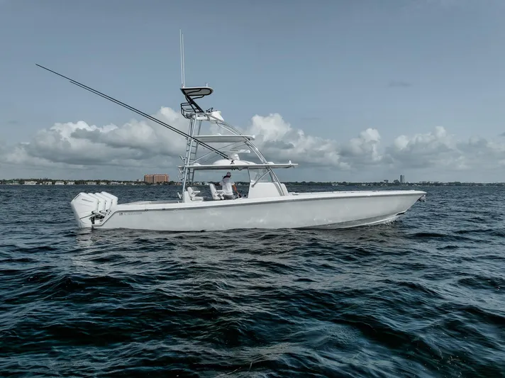  Yacht Photos Pics 2024 Contender 44 ST boat on open water under cloudy sky.
