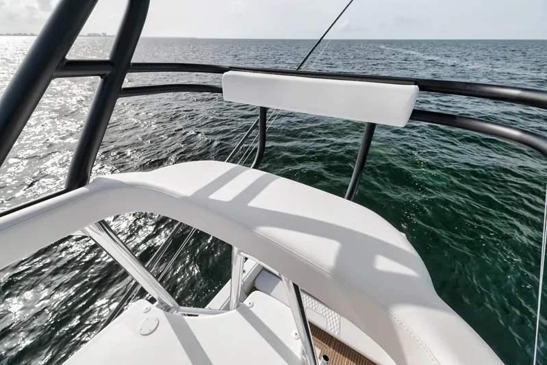  Yacht Photos Pics 2024 Contender 44 ST boat, white seating, ocean view, sunny day, sleek design.