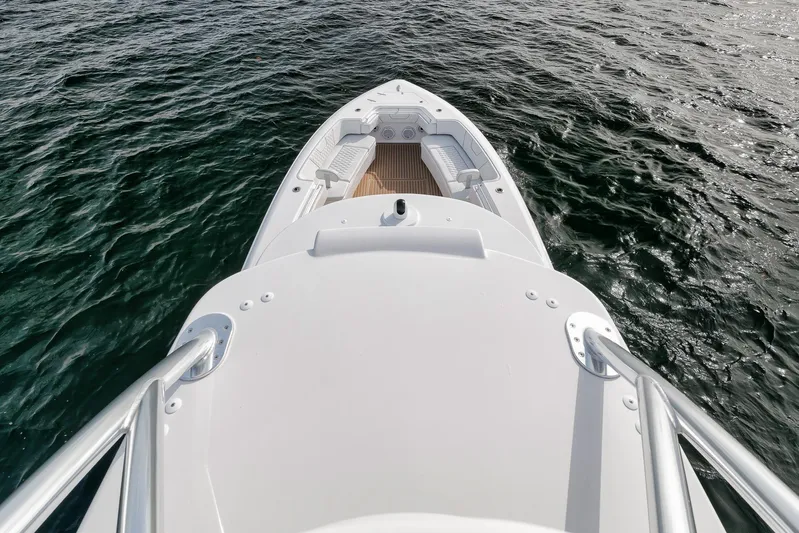  Yacht Photos Pics 2024 Contender 44 ST boat on water, showcasing sleek design and spacious deck.