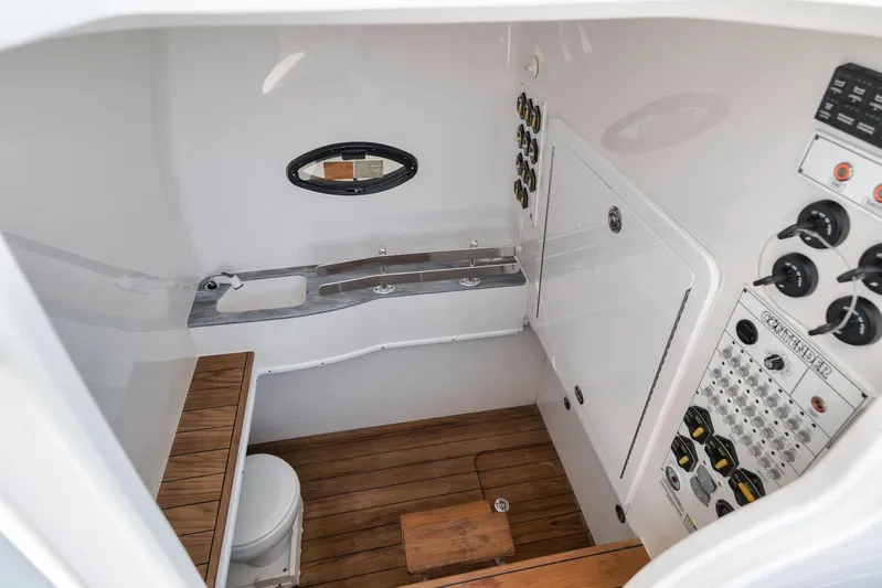  Yacht Photos Pics 2024 Contender 44 ST boat interior with control panel, wooden flooring, and compact amenities.