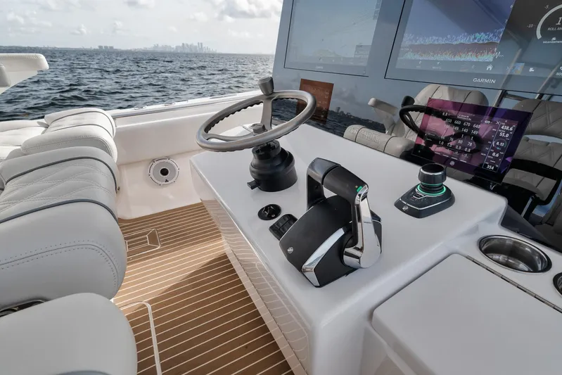  Yacht Photos Pics 2024 Contender 44 ST boat helm with modern controls and ocean view.