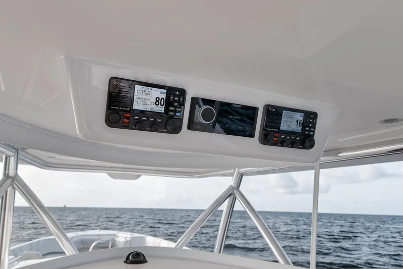  Yacht Photos Pics 2024 Contender 44 ST boat dashboard with navigation instruments, ocean view in background.