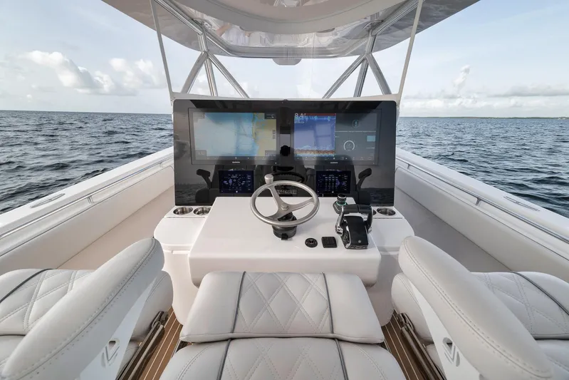  Yacht Photos Pics 2024 Contender 44 ST boat cockpit with advanced navigation system on open water.