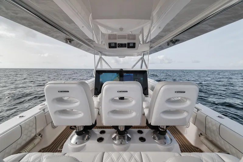  Yacht Photos Pics 2024 Contender 44 ST boat interior with three white seats, ocean view.
