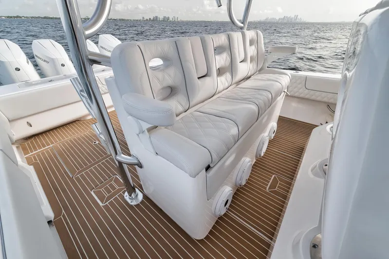  Yacht Photos Pics 2024 Contender 44 ST boat interior with cushioned seating and ocean view.
