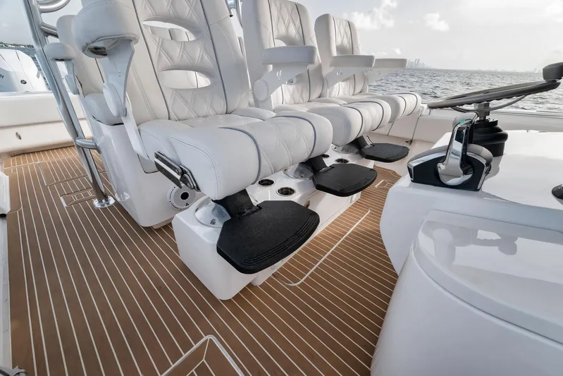  Yacht Photos Pics 2024 Contender 44 ST boat interior with luxurious seating and sleek wooden flooring.