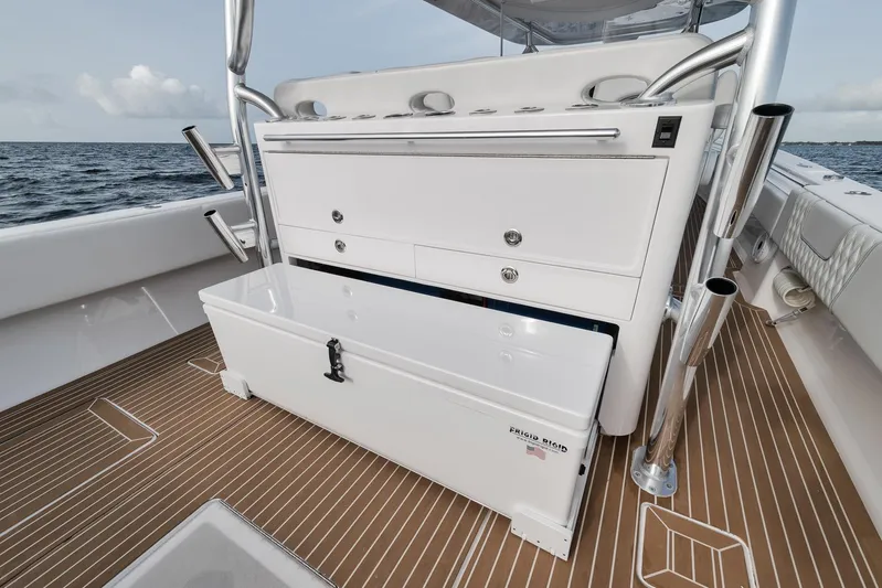  Yacht Photos Pics 2024 Contender 44 ST boat with storage compartments on a wooden deck.