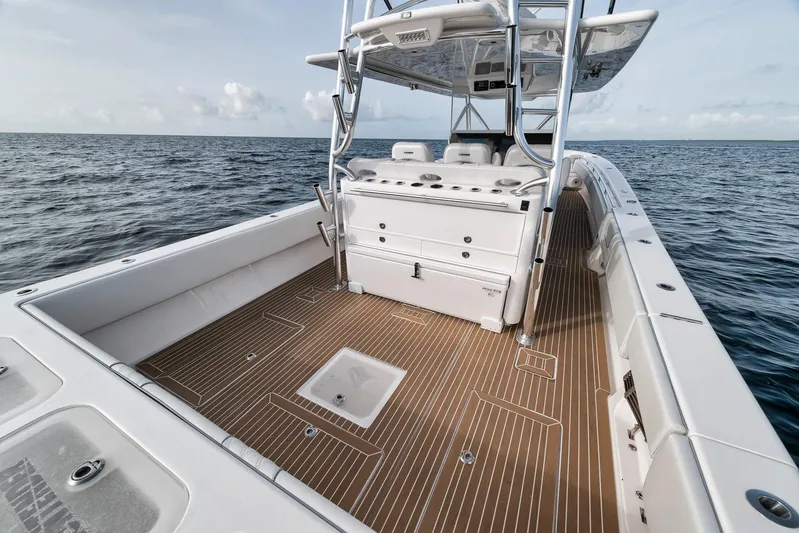  Yacht Photos Pics 2024 Contender 44 ST boat with spacious deck, sleek design, and ocean backdrop.