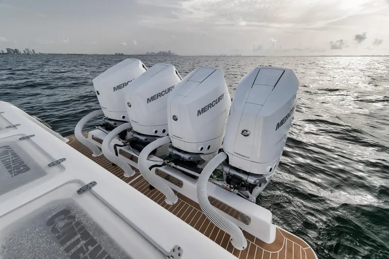  Yacht Photos Pics 2024 Contender 44 ST boat with four Mercury outboard engines on open water.