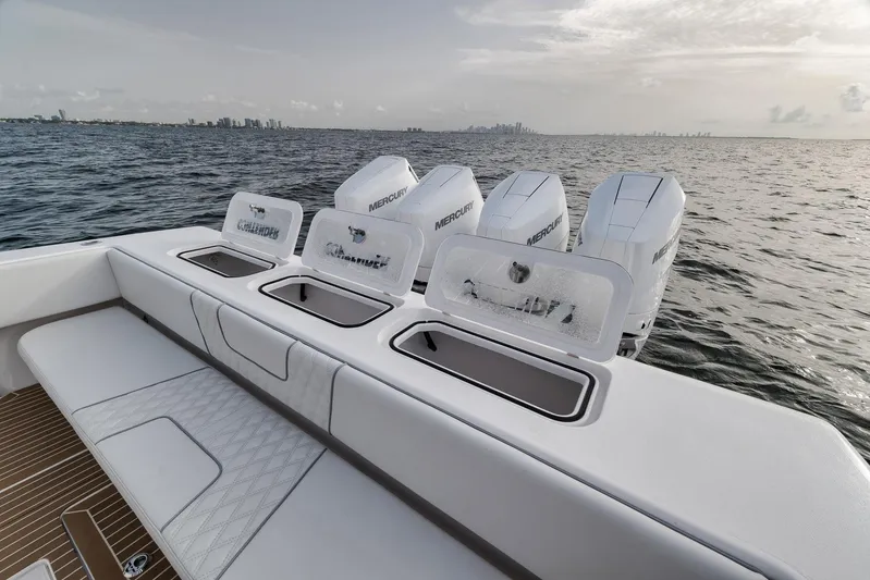  Yacht Photos Pics 2024 Contender 44 ST boat with powerful outboard engines on open water.