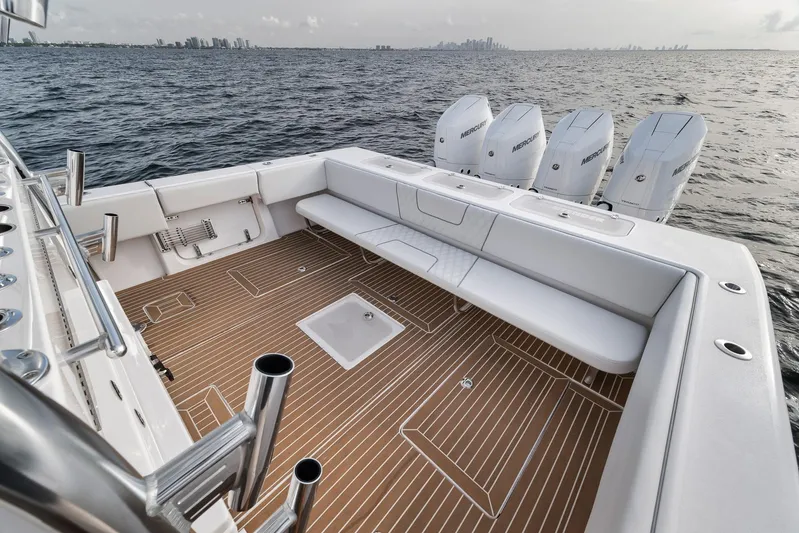  Yacht Photos Pics 2024 Contender 44 ST boat with spacious deck and four powerful engines on open water.