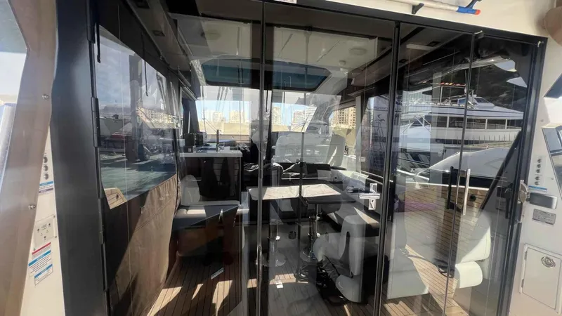  Yacht Photos Pics 2024 Galeon 410 HTC yacht interior with glass doors and modern seating.