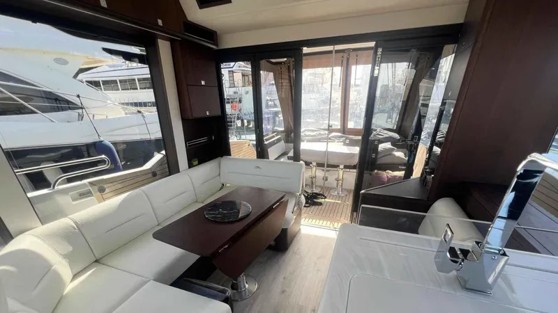  Yacht Photos Pics Luxurious interior of 2024 Galeon 410 HTC yacht with modern seating and dining area.